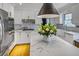 Bright kitchen with stainless appliances, marble countertops and backsplash, and hardwood floors at 3519 Sunderland Ne Way, Brookhaven, GA 30319