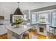 Well-lit kitchen featuring white cabinets, hardwood floors, stainless steel appliances, and a breakfast bar at 3519 Sunderland Ne Way, Brookhaven, GA 30319