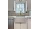Bright kitchen features a modern farmhouse sink with a gold faucet and marble backsplash at 3519 Sunderland Ne Way, Brookhaven, GA 30319