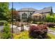 Private backyard with a fire pit, lush landscaping, mature trees, patio seating, and an expansive deck for entertaining at 12815 Oak Falls Dr, Alpharetta, GA 30009