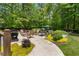 Landscaped backyard featuring a grill, a pizza oven, and a fire pit at 12815 Oak Falls Dr, Alpharetta, GA 30009