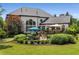 An expansive backyard features a putting green, patio, seating, and professional landscaping at 12815 Oak Falls Dr, Alpharetta, GA 30009