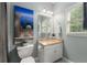 Charming bathroom features a granite vanity, framed mirror, a window and nice decor at 12815 Oak Falls Dr, Alpharetta, GA 30009