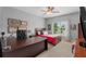 Comfortable bedroom features a ceiling fan, large window, and framed wall art at 12815 Oak Falls Dr, Alpharetta, GA 30009