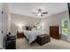 Bedroom featuring a ceiling fan, a window, carpeted floors, and neutral-colored walls at 12815 Oak Falls Dr, Alpharetta, GA 30009