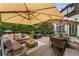 Outdoor deck with patio furniture, a sun umbrella, and a view of the backyard at 12815 Oak Falls Dr, Alpharetta, GA 30009