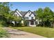 Striking two-story home showcasing a brick exterior, manicured lawn and professional landscaping at 12815 Oak Falls Dr, Alpharetta, GA 30009