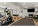 Basement gym with exercise equipment, and a wall-mounted TV at 12815 Oak Falls Dr, Alpharetta, GA 30009