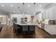Modern kitchen with white cabinets, stainless steel appliances, large island, and hardwood floors at 12815 Oak Falls Dr, Alpharetta, GA 30009