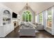 Bright living room with a fireplace, high ceilings, and large windows with natural light at 12815 Oak Falls Dr, Alpharetta, GA 30009