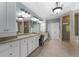 The main bathroom features double vanities, a glass shower, and a soaking tub at 12815 Oak Falls Dr, Alpharetta, GA 30009