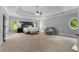 Expansive main bedroom suite features a tray ceiling, sitting area, and great natural light at 12815 Oak Falls Dr, Alpharetta, GA 30009