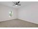 Carpeted bedroom with large window, white trim, ceiling fan, and lots of natural light at 1488 Campbell Rd, Covington, GA 30014