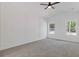 Vaulted ceiling bedroom with large windows, carpet, white trim, ceiling fan, and lots of natural light at 1488 Campbell Rd, Covington, GA 30014