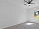 Carpeted bedroom with large window, white trim, ceiling fan, and lots of natural light at 1488 Campbell Rd, Covington, GA 30014