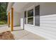 Close-up of a home's exterior showcasing wood columns and stylish window shutters at 1488 Campbell Rd, Covington, GA 30014