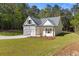 Newly built home featuring a pristine lawn, attached garage, and inviting exterior design at 1488 Campbell Rd, Covington, GA 30014