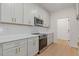 Sleek kitchen featuring white cabinets, stainless steel appliances, and quartz countertops at 1488 Campbell Rd, Covington, GA 30014