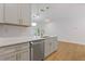 Modern kitchen with stainless steel dishwasher, quartz countertops, and stylish gold hardware at 1488 Campbell Rd, Covington, GA 30014