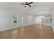 Open-concept living room showcasing hardwood floors, recessed lights, and a view into the kitchen at 1488 Campbell Rd, Covington, GA 30014