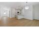 Bright open-concept living space featuring hardwood floors and modern kitchen with bar seating at 1488 Campbell Rd, Covington, GA 30014