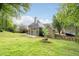 Spacious backyard featuring a lawn and exterior of the home, set among mature trees at 1593 Brynwood Nw Ct, Acworth, GA 30101