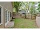 Fenced backyard includes a stone patio, small grassy area, and access to exterior doors and windows at 1593 Brynwood Nw Ct, Acworth, GA 30101