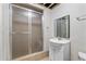 Basement bathroom offers shower stall, vanity, and storage under the sink at 1593 Brynwood Nw Ct, Acworth, GA 30101