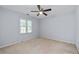This carpeted bedroom with a ceiling fan and window offers a relaxing retreat at 1593 Brynwood Nw Ct, Acworth, GA 30101