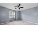 This cozy bedroom has neutral walls and a ceiling fan for added comfort at 1593 Brynwood Nw Ct, Acworth, GA 30101