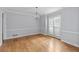 Dining room with hardwood floors, white trim, and a modern chandelier adjacent to a window at 1593 Brynwood Nw Ct, Acworth, GA 30101