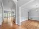 Dining room featuring hardwood floors and a modern chandelier, complemented by a partial view of the living room at 1593 Brynwood Nw Ct, Acworth, GA 30101