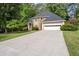 Charming home featuring a stone facade, well-manicured lawn, and a two-car garage with a long concrete driveway at 1593 Brynwood Nw Ct, Acworth, GA 30101