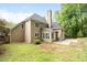 Rear exterior view of home with a chimney, showing windows, doors, and a patio at 1593 Brynwood Nw Ct, Acworth, GA 30101