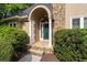 Inviting front entrance with stone archway, decorative columns, and a green front door at 1593 Brynwood Nw Ct, Acworth, GA 30101