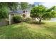 Beautiful lawn with lush green grass and a mature Japanese maple tree in front of a charming stone home at 1593 Brynwood Nw Ct, Acworth, GA 30101