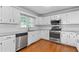 Spacious kitchen showcasing stainless steel appliances, white cabinets, granite countertops, and a window view at 1593 Brynwood Nw Ct, Acworth, GA 30101