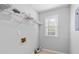 Well-lit laundry room includes a window and wire shelving for convenient storage at 1593 Brynwood Nw Ct, Acworth, GA 30101