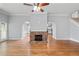 Open-concept living room featuring a stone fireplace, hardwood floors and views to the kitchen and backyard at 1593 Brynwood Nw Ct, Acworth, GA 30101