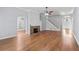 Large living room with hardwood floors, a stone fireplace and a staircase leading to the second floor at 1593 Brynwood Nw Ct, Acworth, GA 30101