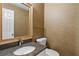 Elegant powder room featuring granite countertop, modern faucet, textured wallpaper, and a framed mirror at 1593 Brynwood Nw Ct, Acworth, GA 30101