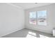Clean bedroom with neutral carpet, base trim, and bright double windows offering natural light at 464 Village Ln, Fairburn, GA 30213