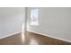 Bedroom featuring light-colored walls, wood floors and a window letting in natural light at 464 Village Ln, Fairburn, GA 30213
