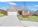 Charming brick home with a well-manicured lawn and attached two-car garage at 464 Village Ln, Fairburn, GA 30213