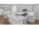 Modern kitchen featuring stainless steel appliances, gray cabinetry, and a quartz island at 464 Village Ln, Fairburn, GA 30213