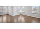 Bright living room with hardwood floors, lots of natural light and a white door at 464 Village Ln, Fairburn, GA 30213