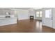 Open concept living space with a modern kitchen, fireplace and door to the outside at 464 Village Ln, Fairburn, GA 30213