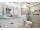 Bright bathroom featuring a glass enclosed shower, white cabinets and modern lighting fixtures at 170 Elysian Nw Way, Atlanta, GA 30327