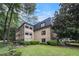 Well-maintained multi-story home with a black roof, neutral stucco and a professionally landscaped yard at 170 Elysian Nw Way, Atlanta, GA 30327