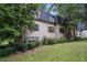 View of home with lush landscaping, shuttered windows and grassy lot at 170 Elysian Nw Way, Atlanta, GA 30327